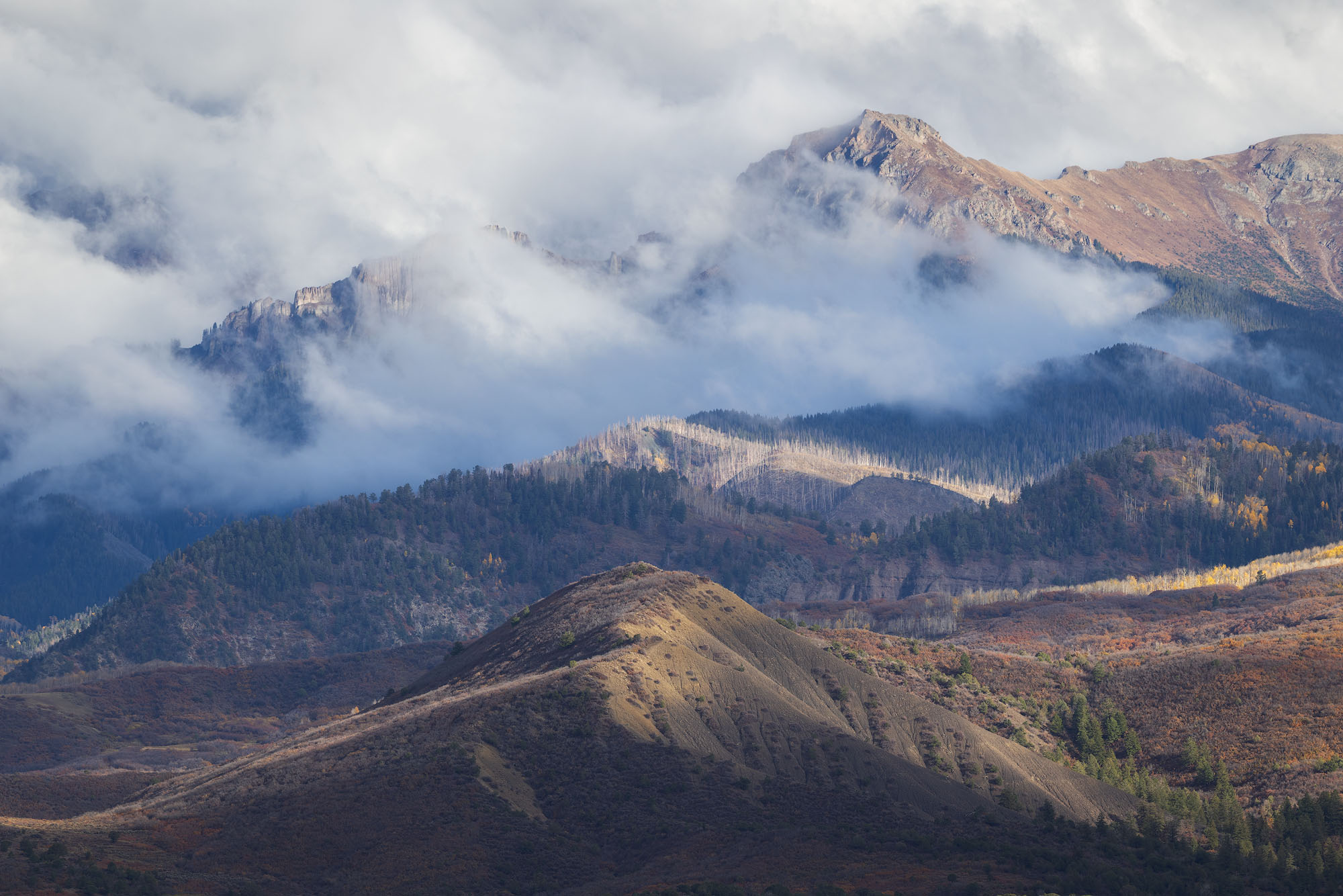 Cimarron Mountain Layers in Autumn A view of the Cimarron Mountains on a stormy day in autumn. Southwestern Colorado.