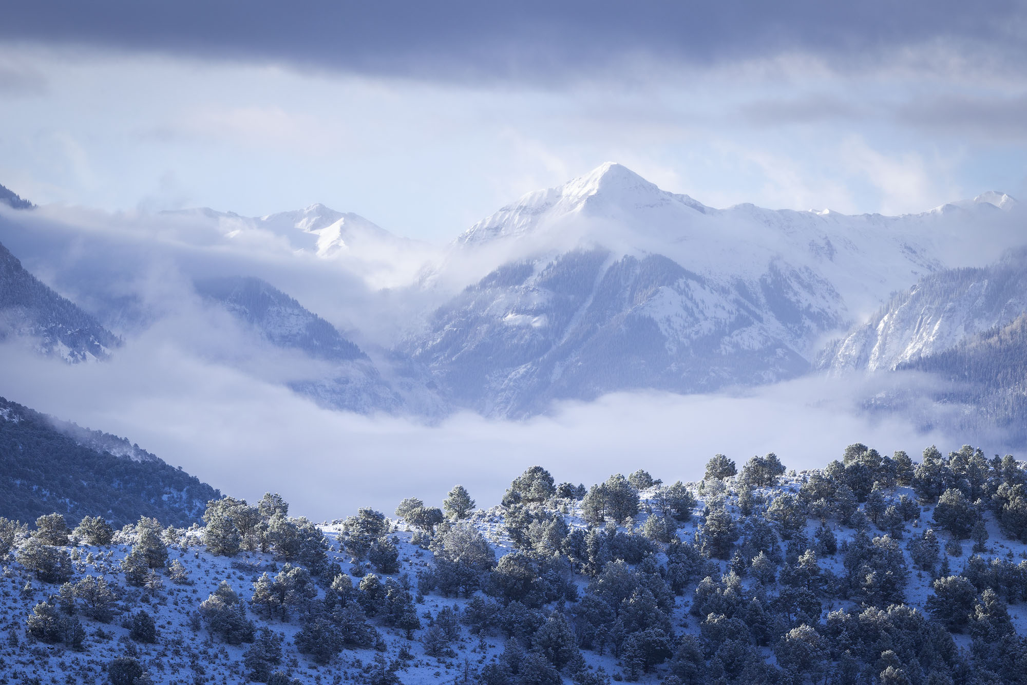 Low Clouds in Winter, Mount Abrams Low clouds fill the valley below a snow-covered Mount Abrams in Colorado's San Juan Mountains.