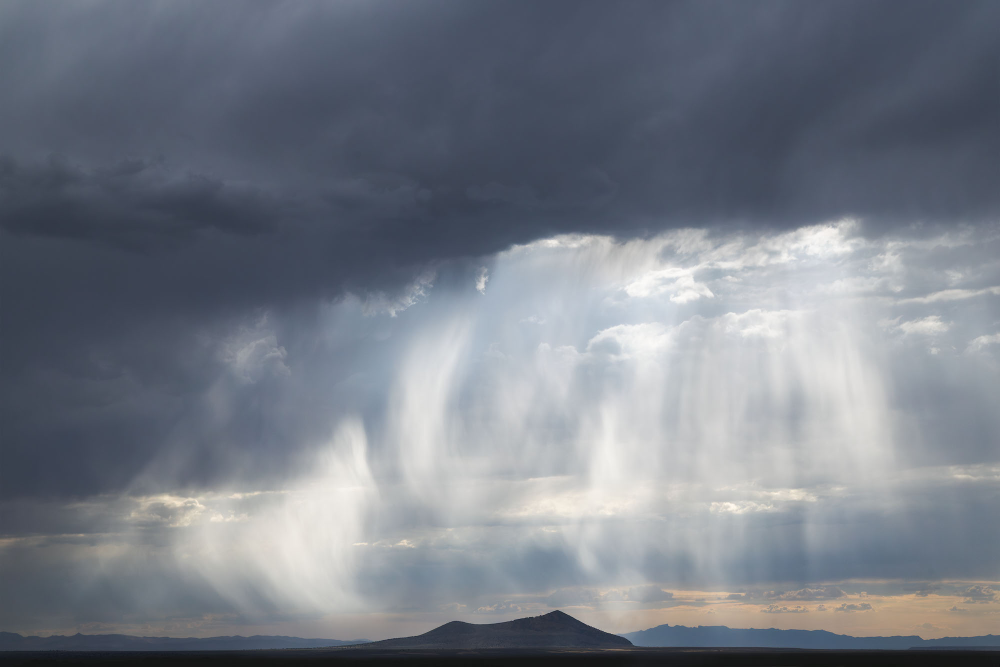 Falling Light Dramatic light beams shine down over mountains in Nevada's Great Basin.